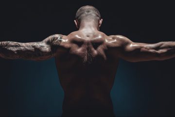 muscular male Bodybuilder posing in studio over black